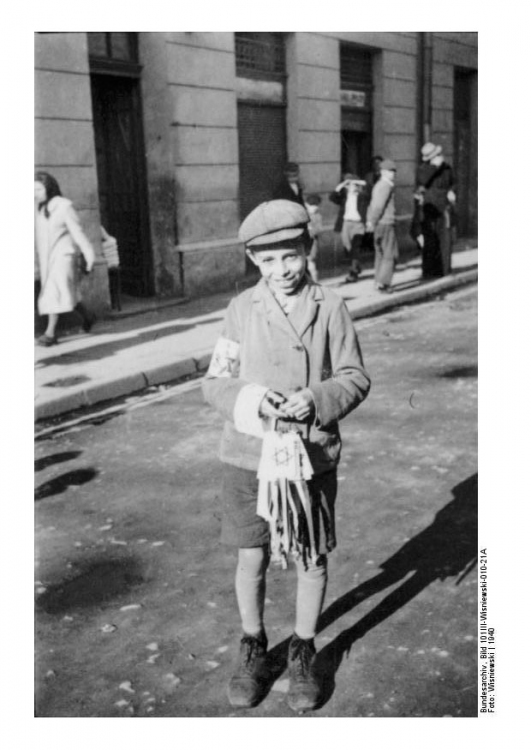A young Jewish boy sells white armbands in Radom, Poland, 1940
